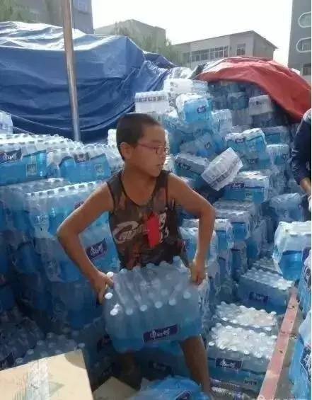 志愿者把矿泉水送到救援者手中志愿者携手传递生命之源，矿泉水送到救援者手中